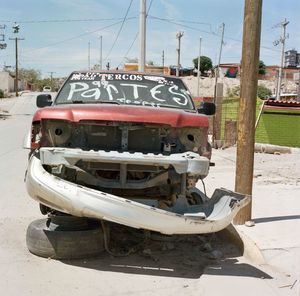 View of abandoned boats on road against sky