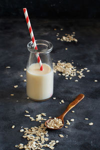 High angle view of oat flake with milk against black background