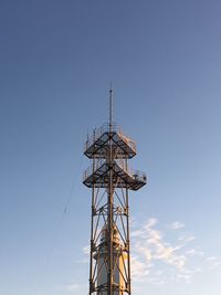 Low angle view of communications tower against sky