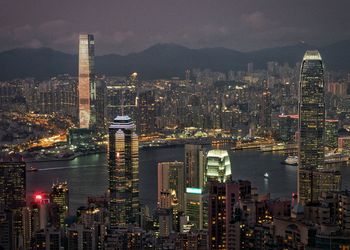 Illuminated cityscape against sky at night