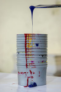 Close-up of paint with container on table