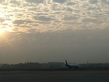 Boat in sea at sunset