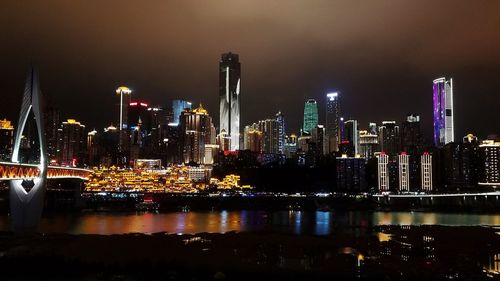 Illuminated buildings against sky at night