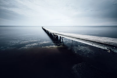 Pier over sea against sky