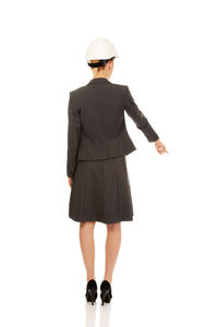 Rear view of woman standing against white background