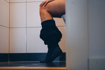 Low section of woman in toilet