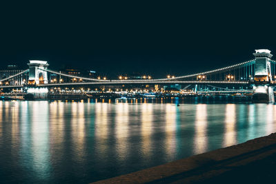 Low angle view of illuminated chain bridge at night