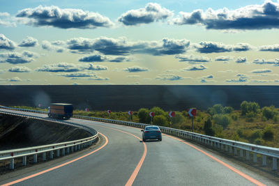 Cars on highway against sky