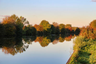 Reflection of trees in lake against sky during autumn