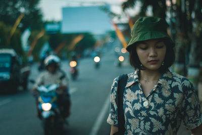 Portrait of a young woman pedestrian walk in city