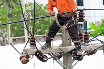 High voltage power line maintenance. electrician at work. electrical technician working on electric