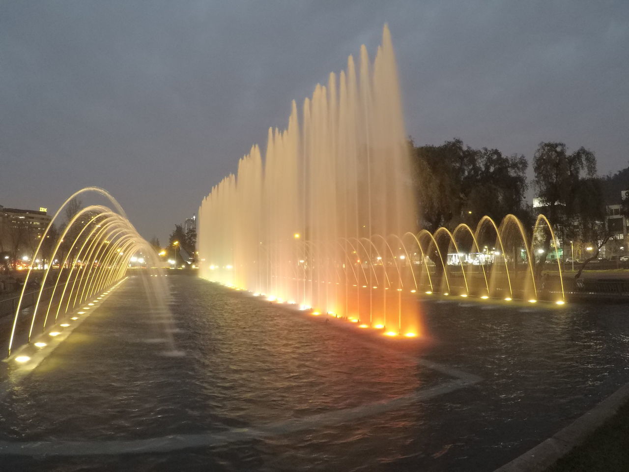 VIEW OF ILLUMINATED CITY AT NIGHT