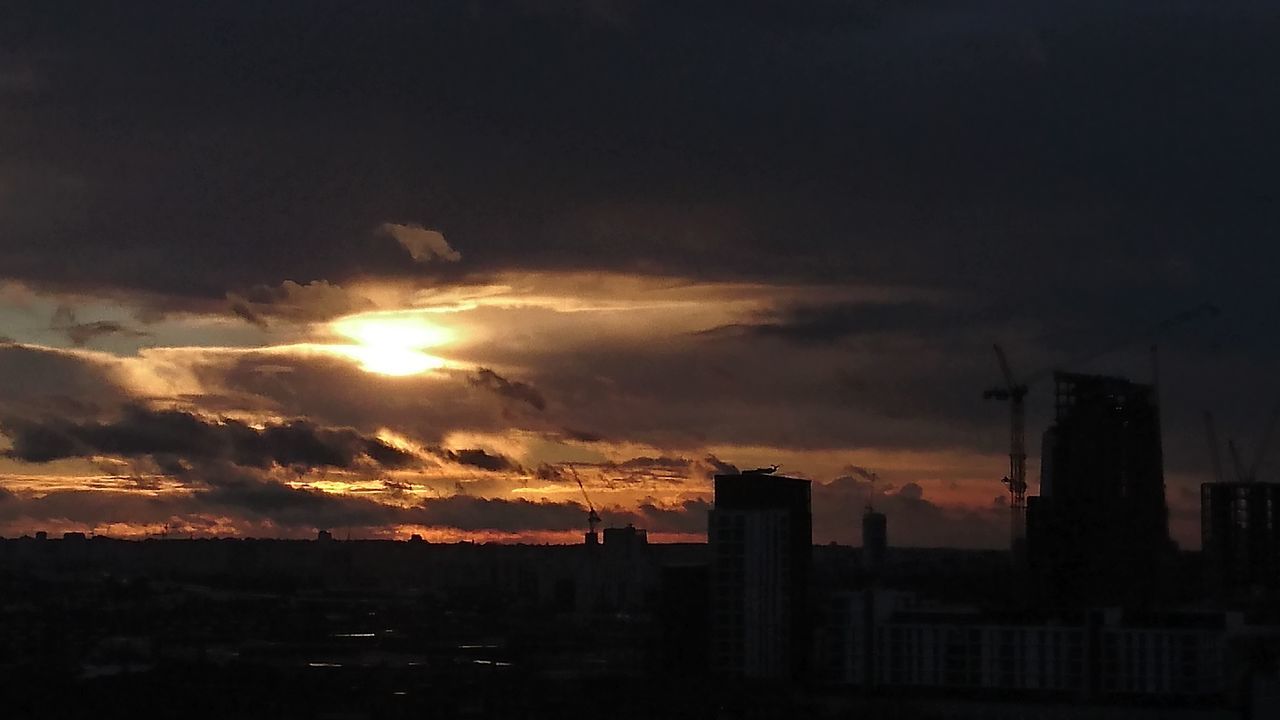 SILHOUETTE CITYSCAPE AGAINST SKY AT SUNSET