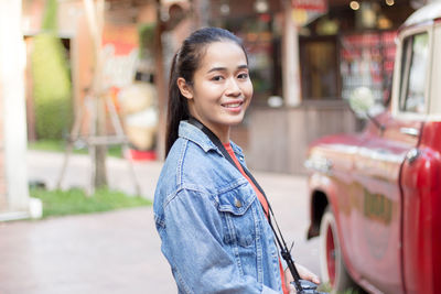 Portrait of a smiling young woman in city