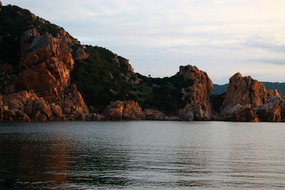 Scenic view of rocks in sea against sky