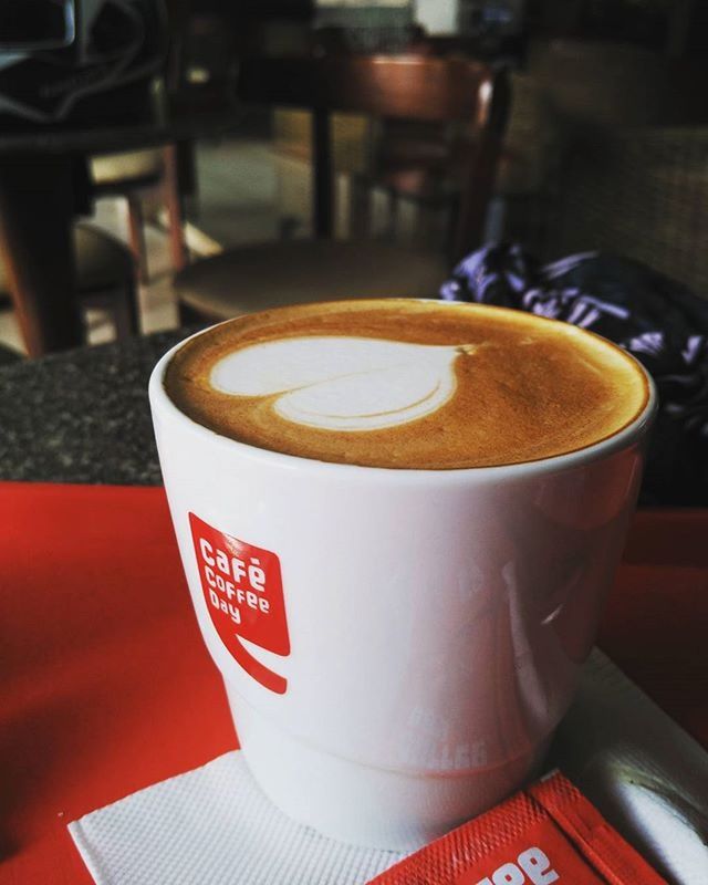 food and drink, drink, coffee cup, coffee - drink, refreshment, table, coffee, saucer, frothy drink, freshness, indoors, close-up, still life, focus on foreground, cafe, cup, cappuccino, froth art, spoon, no people