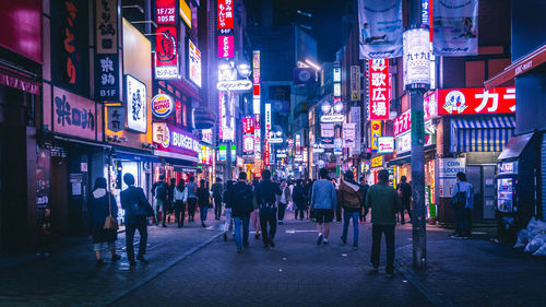 Group of people in front of illuminated building at night