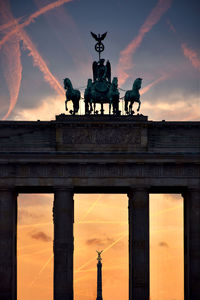 Quadriga statue on the brandenburg gate against sky during sunset