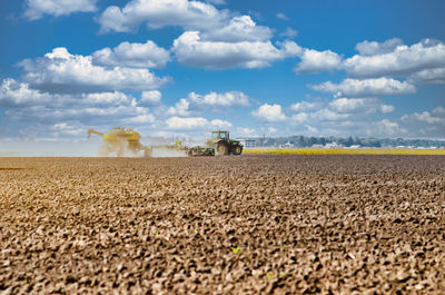 Tractor plowing field. tractor plow soil cultivating. cultivated land and soil tillage. 