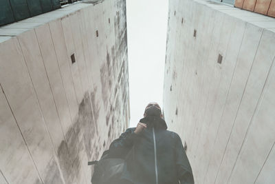 Low angle view of man standing by building