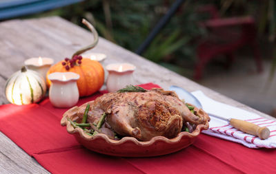 Close-up of roast chicken in container on table