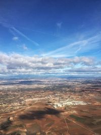 Aerial view of landscape against blue sky