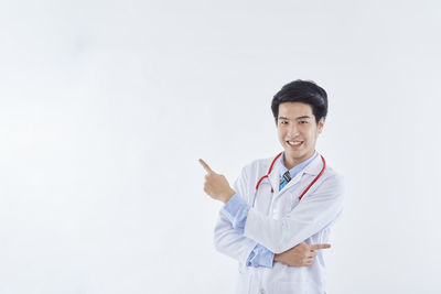 Young man standing against white background