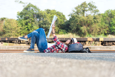 Rear view of senior man sitting on mobile phone