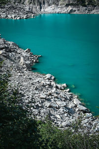 High angle view of rocks on mountain lake beach