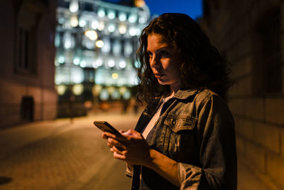 Man using mobile phone in city