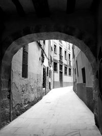 Empty alley amidst buildings in city