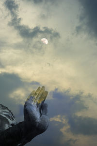 Low angle view of person paragliding against sky