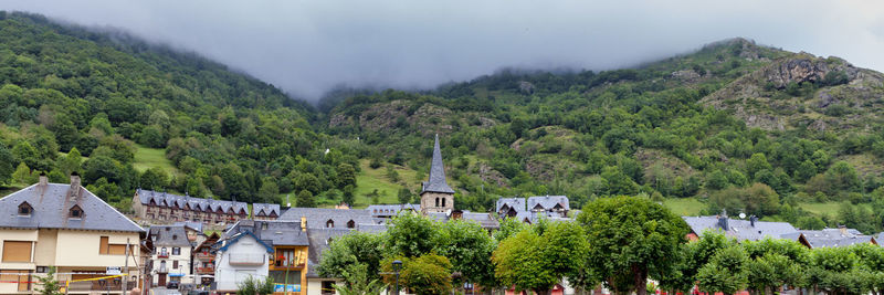 Scenic view of trees and buildings against sky