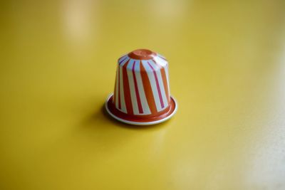 Close-up of cake on table against yellow background