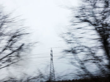 Low angle view of electricity pylon against sky