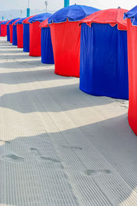 Row of multi colored umbrellas on footpath