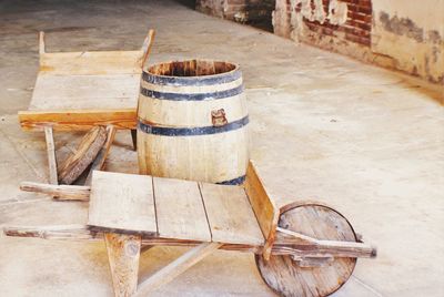 Wine cask and wooden cart outside winery