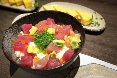 High angle view of chopped fruits in bowl on table