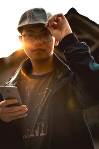 Portrait of young man using mobile phone