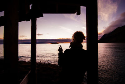 Rear view of a woman overlooking calm lake