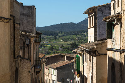 Buildings in town against sky