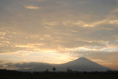 Scenic view of silhouette mountains against sky during sunset