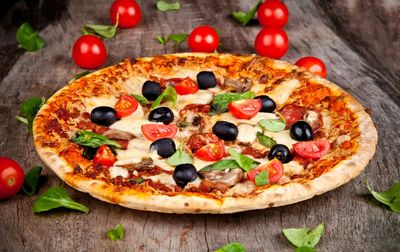 High angle view of pizza on wooden table