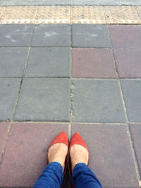 Low section of woman standing on tiled floor