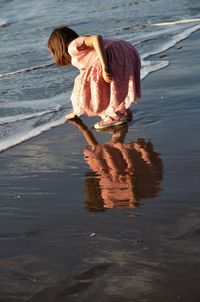 Woman with umbrella on beach