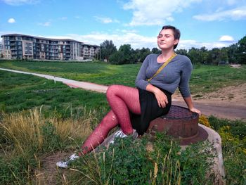 Portrait of smiling woman sitting on land