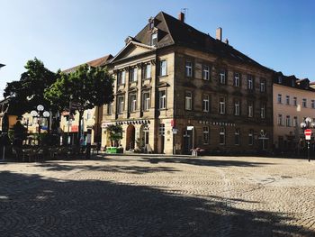 Street by building against clear sky