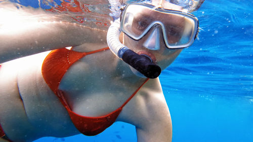 Close-up of young woman swimming in pool