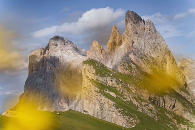 Scenic view of mountains against cloudy sky