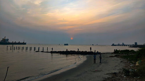 Scenic view of beach against sky during sunset